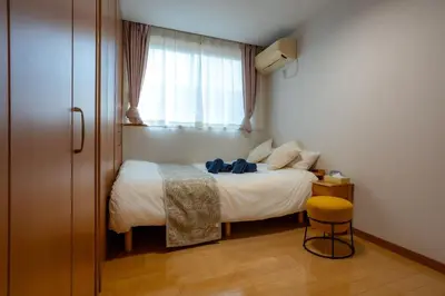 a small bedroom with a bed and a window at Tokyo Koiwa European Luxury Mansion 4 Bedrooms2 ToiletsEV HanedaNarita Direct Max 8 Guests in Tokyo