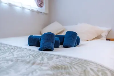 a group of blue towels sitting on a bed at Tokyo Koiwa European Luxury Mansion 4 Bedrooms2 ToiletsEV HanedaNarita Direct Max 8 Guests in Tokyo