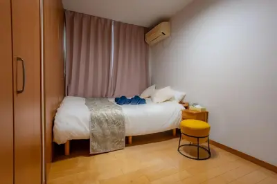 a bedroom with a bed and a yellow stool at Tokyo Koiwa European Luxury Mansion 4 Bedrooms2 ToiletsEV HanedaNarita Direct Max 8 Guests in Tokyo