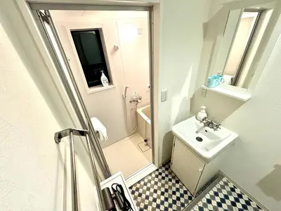 a small bathroom with a sink and a shower at Yama Hotel Akabane 101 in Tokyo