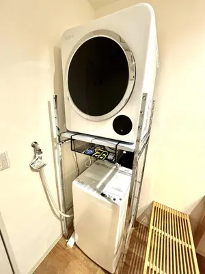 a television on a shelf next to a small refrigerator at Yama Hotel Akabane 101 in Tokyo