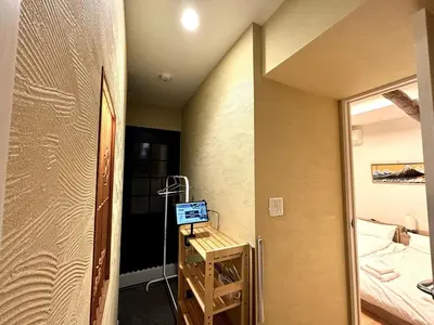 a small room with a mirror and a bathroom at Yama Hotel Akabane 101 in Tokyo