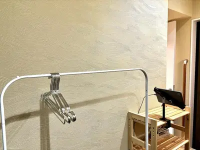 a bathroom with a blow dryer on a wall at Yama Hotel Akabane 101 in Tokyo