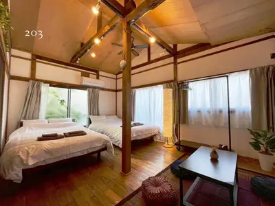 a bedroom with two beds and a large window at YutoVillageHouse Sweetexperience in Ikebukuro YVM in Tokyo