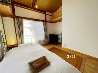 a bedroom with a bed with a towel on it at YutoVillageHouse Sweetexperience in Ikebukuro YVM in Tokyo