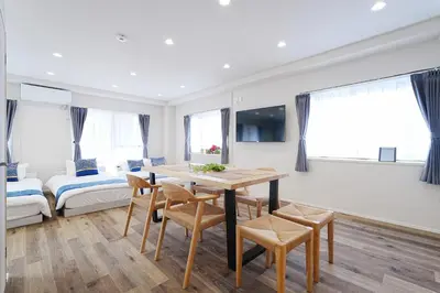 a living room with a table and chairs and a bed at Unite Stay URAYASU 101 8 minutes by car or 15 minutes by bus to Disneyland in Tokyo