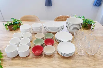 a table with white plates and glasses on it at Unite Stay URAYASU 101 8 minutes by car or 15 minutes by bus to Disneyland in Tokyo