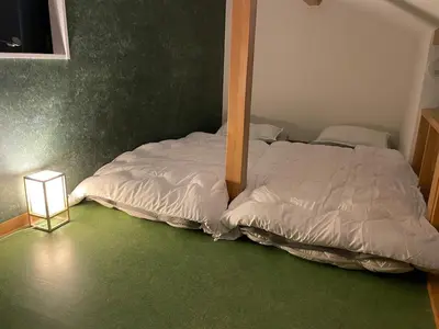 a bed sitting in a room with a bed sqor at Yama Hotel Akabane 201 in Tokyo