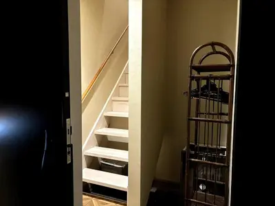 a room with a stair case with white stairs at Yama Hotel Akabane 201 in Tokyo