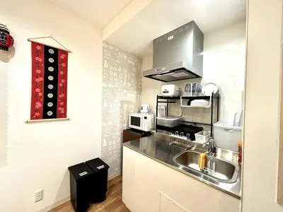 a small kitchen with a sink and a microwave at Yama Hotel Akabane 201 in Tokyo