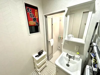 a white bathroom with a sink and a mirror at Yama Hotel Akabane 201 in Tokyo