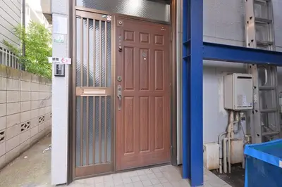 a pair of wooden doors in a building at Aoi Bld 1F in Tokyo