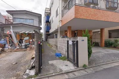 a fence in front of a building next to a street at Aoi Bld 2F in Tokyo