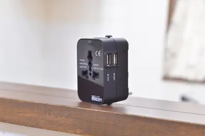 a black electronic device sitting on a wooden table at Aoi Bld 2F in Tokyo