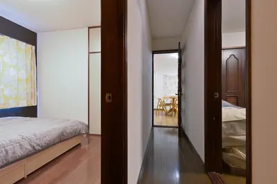 a bedroom with a bed and a closet and a mirror at Aoi Bld 2F in Tokyo
