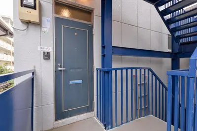 a blue door on the side of a building at Aoi Bld 2F in Tokyo