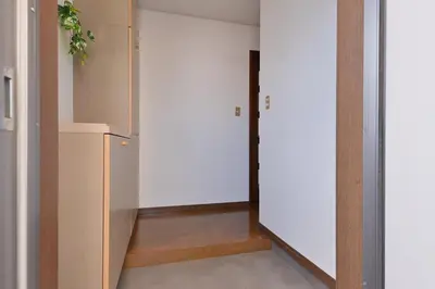 a room with a hallway with a white refrigerator at Aoi Bld 3F in Tokyo