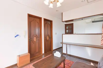 a living room with wooden doors and a table at Aoi Bld 3F in Tokyo