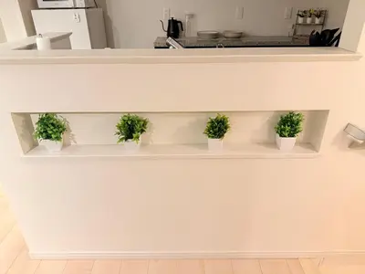 three potted plants sitting on a shelf in a kitchen at \u6c60\u888b\u946b\u306e\u5c4b in Tokyo