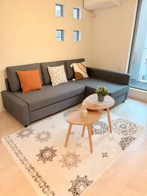 a living room with a couch and a table at \u6c60\u888b\u946b\u306e\u5c4b in Tokyo