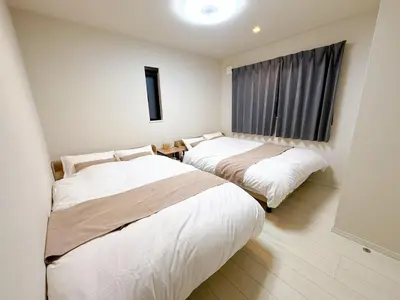 a room with two beds and a window at Tabi in Tokyo in Tokyo