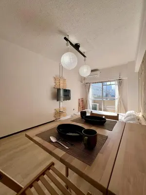 a room with a wooden table with two bowls on it at Higashi-Ikebukuro Japanese Style in Tokyo