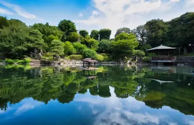 a pond in a garden with a gazebo at Higashi-Ikebukuro Japanese Style in Tokyo