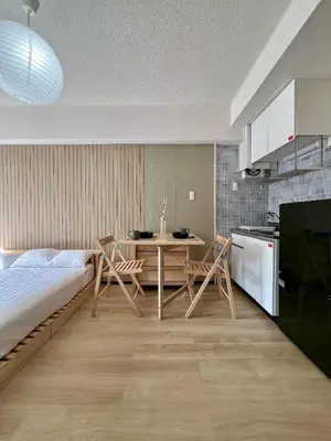 a bedroom with a bed and a table and chairs at Higashi-Ikebukuro Japanese Style in Tokyo