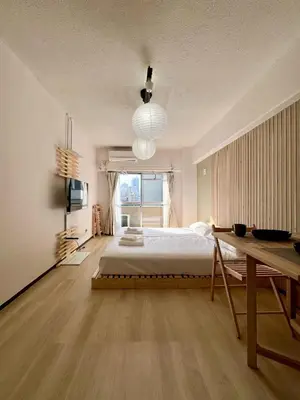 a bedroom with a large bed and a large window at Higashi-Ikebukuro Japanese Style in Tokyo