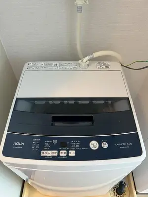 a printer with a cord on top of a table at Higashi-Ikebukuro Japanese Style in Tokyo