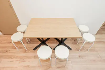 a wooden table with four white chairs around it at \u30a6\u30a3\u30f3\u30b0\u30b2\u30b9\u30c8\u30cf\u30a6\u30b9\u79cb\u8449\u539f301 in Tokyo