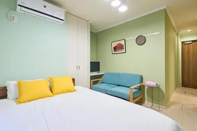 a bedroom with a bed and a blue chair at K2 4min from sta 7min to shinjuku sta quiet area in Tokyo