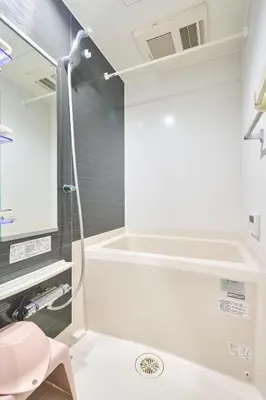 a bathroom with a shower and a pink stool at K2 4min from sta 7min to shinjuku sta quiet area in Tokyo