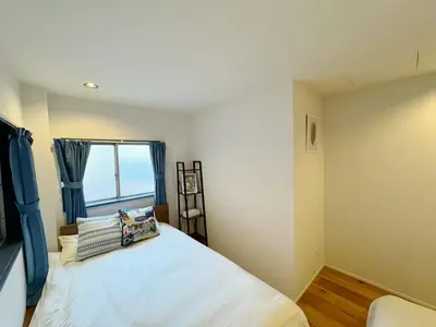 a bedroom with a large bed and a window at \u7af9\u9db4\u65c5\u9928 in Tokyo