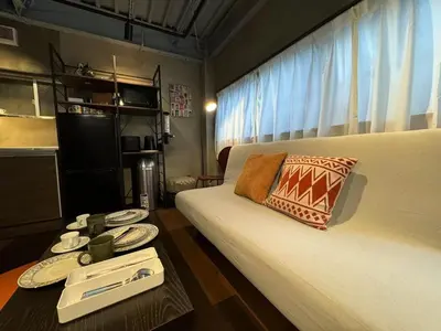a small room with a bed and a table with plates at \u7af9\u9db4\u65c5\u9928 in Tokyo