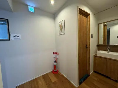 a bathroom with a sink and a mirror and a fire hydrant at \u7af9\u9db4\u65c5\u9928 in Tokyo