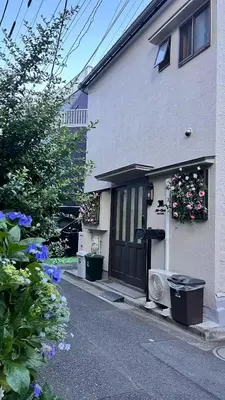 a white house with a black door and flowers at JW-One Skytree in Tokyo