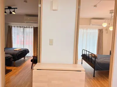 a room with two beds and a mirror at Walking distance to Sunshine, families are welcome and easy to live in in Tokyo