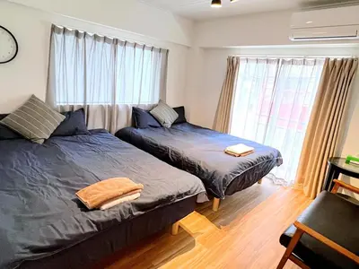 a bedroom with two beds and a window at Walking distance to Sunshine, families are welcome and easy to live in in Tokyo