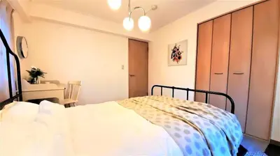 a bedroom with a bed and a table and a desk at Walking distance to Sunshine, families are welcome and easy to live in in Tokyo