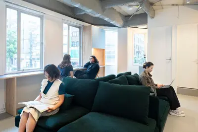 a group of people sitting on a couch in a room at MIDORIso Nihonbashi in Tokyo