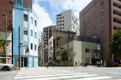 a city street with buildings and a crosswalk at MIDORIso Nihonbashi in Tokyo