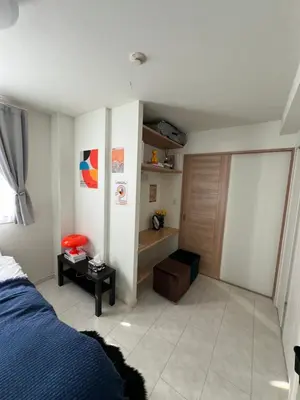 a bedroom with a blue bed and a wooden door at Private Room with elevator only 2 minutes to station in Tokyo