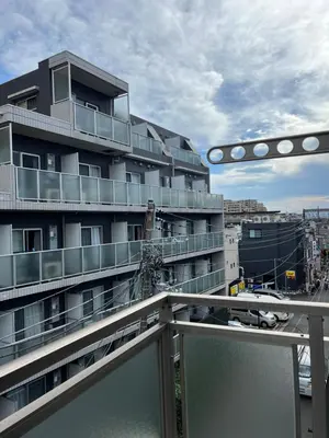 a large apartment building with a balcony at Private Room with elevator only 2 minutes to station in Tokyo
