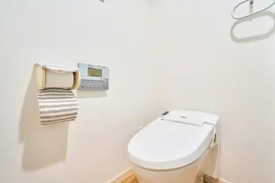 a white bathroom with a toilet and a towel at 3A SHIBUYA Cozy Bright Apartment, 28sqm, free wifi, MAX 5PP in Tokyo