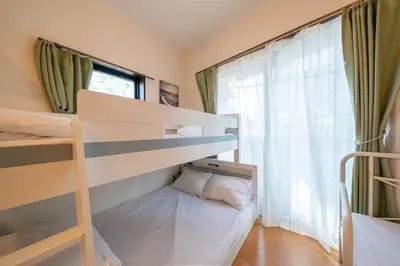 a bedroom with two bunk beds and a window at 3A SHIBUYA Cozy Bright Apartment, 28sqm, free wifi, MAX 5PP in Tokyo