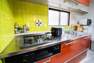 a kitchen with a stove and a sink at 2 bedrooms and 1 living room on the 1st floor, 40sqm house, 10 min walk to Oji 2 min walk to Kajiyara Toden Arakawa Line in Wada