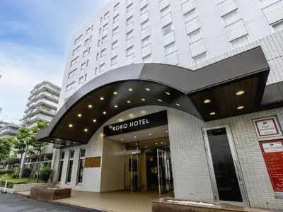 a building with a yoga hotel sign in front of it at KOKO HOTEL Tokyo Nishikasai in Tokyo