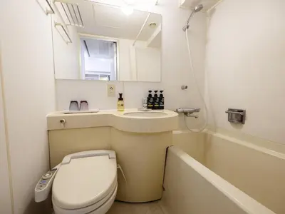 a bathroom with a toilet and a sink and a tub at KOKO HOTEL Tokyo Nishikasai in Tokyo