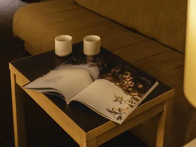 a table with an open book and two candles on it at KOKO HOTEL Tokyo Nishikasai in Tokyo